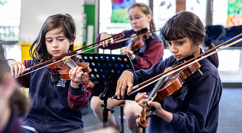 Students playing violin at St Finbar’s Catholic Primary Glenbrook