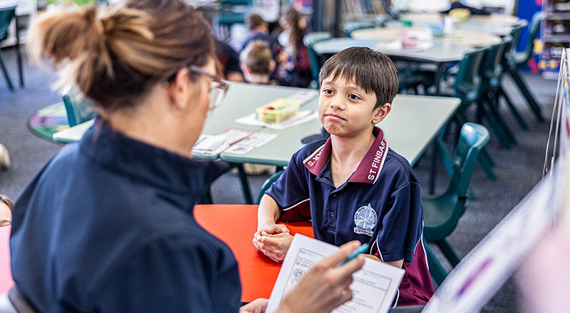 Teacher supporting student at St Finbar's Primary School Glenbrook