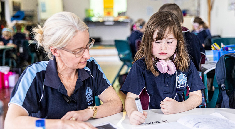 Teacher with student at St Finbar’s Catholic Primary Glenbrook