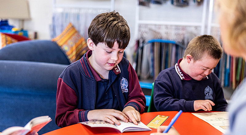 Students reading together in the library at St Finbar’s Catholic Primary Glenbrook