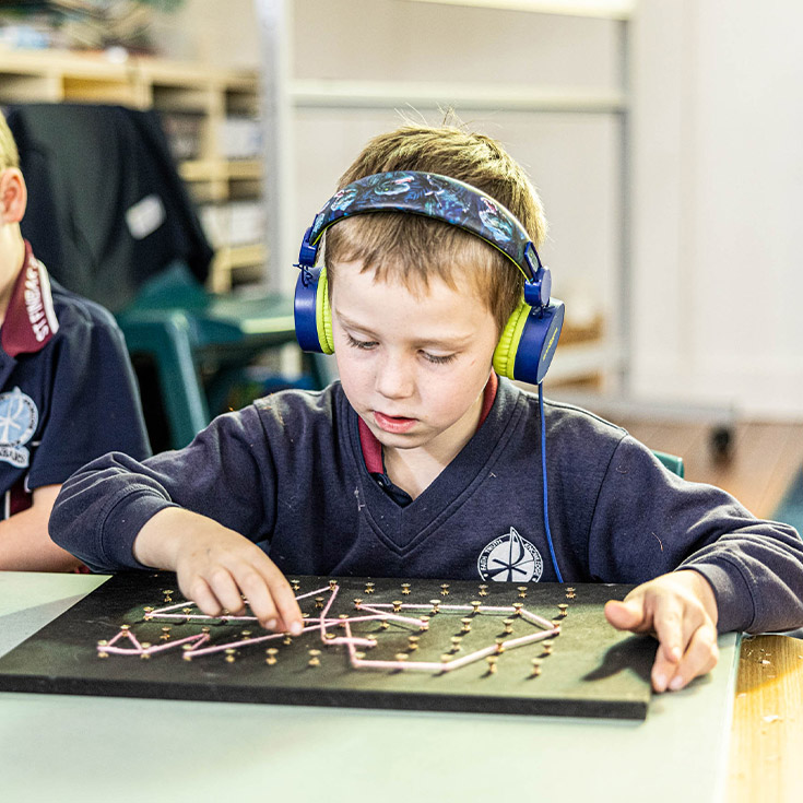 Student wearing headphones at St Finbar’s Catholic Primary Glenbrook