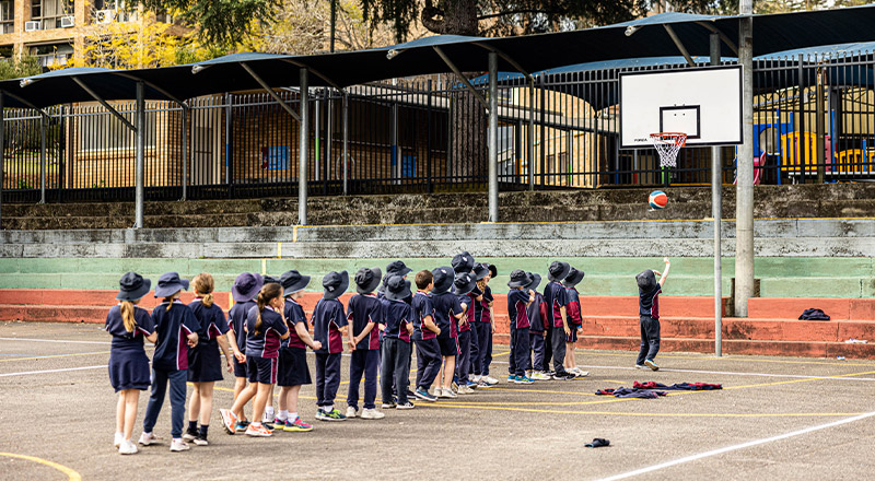 Students at St Finbar’s Catholic Primary Glenbrook lining up to play basketball