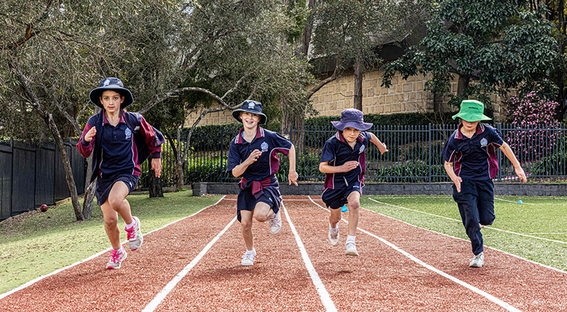 Students running around the school race track at St Finbar’s Catholic Primary Glenbrook