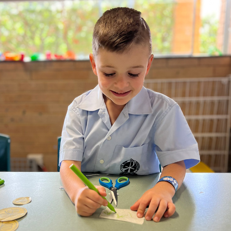 Student doing art and craft at St Finbar's Primary School Glenbrook